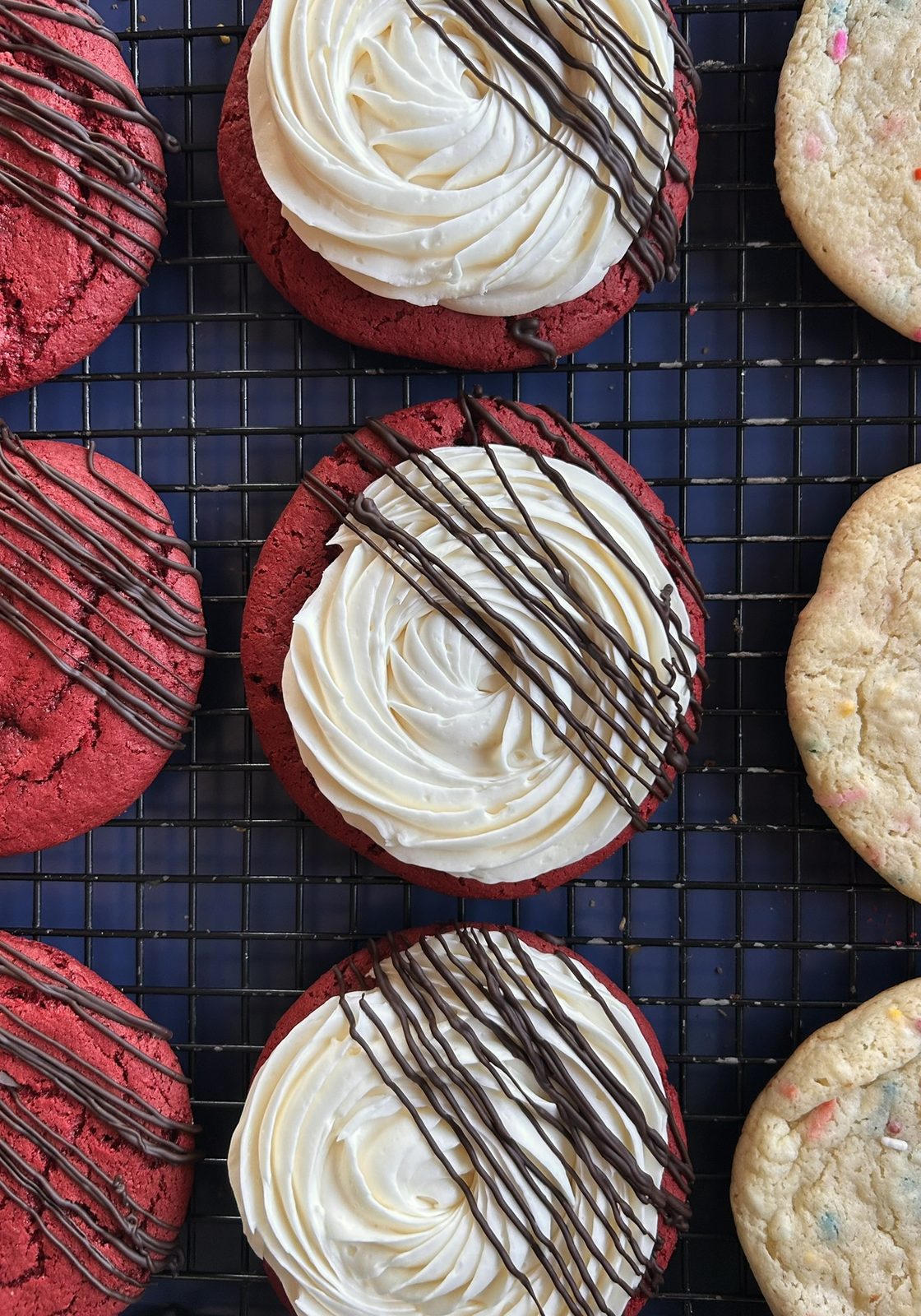 Red velvet cookies with cream cheese frosting and chocolate drizzle