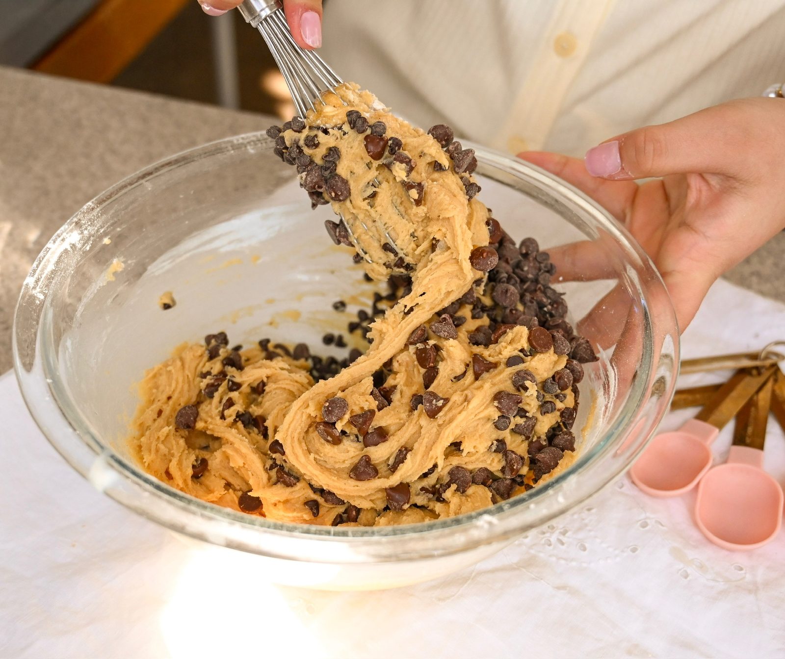 Folding chocolate chips into homemade cookie dough